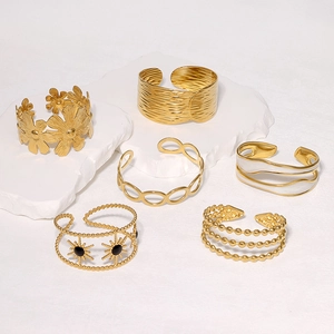 Detailed display of six gold stainless steel bracelets with flower and enamel motifs