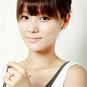 Elegant silver jewelry set with zircon clover necklace, earrings and ring on a model