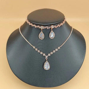 Detailed close-up of bridal jewelry set with rose gold finish and sparkling drop zircons