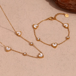 Close-up of 18K gold plated chain with white heart charms and clear zircon stones