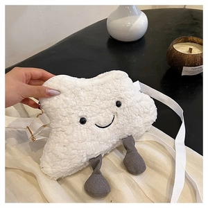 Detail of white plush cloud crossbody bag with smiley face and corduroy legs