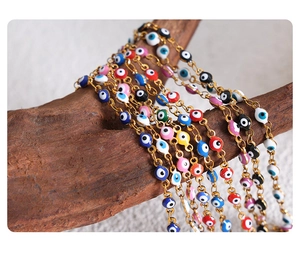Macro view of colorful Evil Eye beads on a delicate golden chain for necklaces