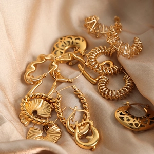 Vintage 18k gold plated stainless steel hollow geometric earrings on silk fabric