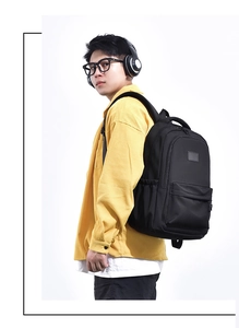 Side view of student wearing black high-capacity backpack with casual stylish outfit