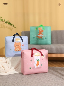 Detail of cartoon quilt storage bags with pink rabbit and blue bear patterns