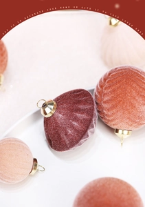 Close-up of luxury flocked velvet Christmas balls in burgundy, caramel, and pink colors