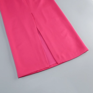 Detail of a rose pink formal dress showing the straight center slit and woven fabric texture