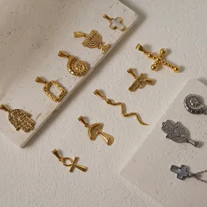 24K gold plated stainless steel pendants featuring snake, cross, and hamsa charms