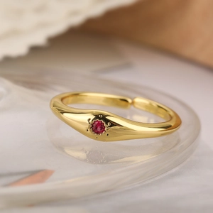 Minimalist 18K gold-plated copper ring with red zircon in a starburst setting