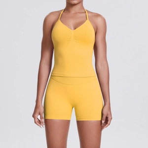 Close-up of ginger yellow yoga set featuring halter V-neck top and high waist shorts