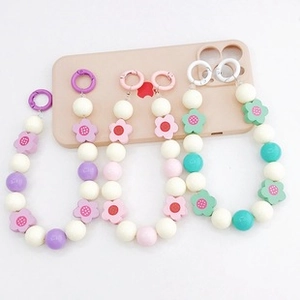 Colorful acrylic bead phone chains with flower shapes and metallic rings in purple and pink