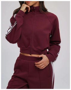 Detail of burgundy windproof sweatshirt jacket with white stripes and zipper pocket