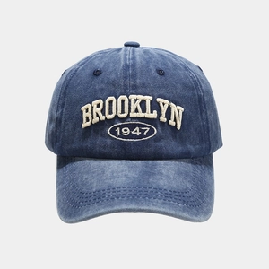 Macro view of BROOKLYN 1947 3D embroidery on washed vintage blue baseball cap