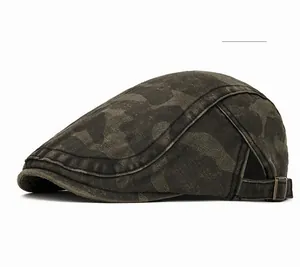 Detail view of olive green camouflage newsboy hat with metal buckle and washed fabric