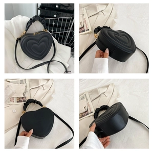Detailed views of heart shaped quilted matte PU leather handbag with gold zippers