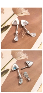 Detail of titanium steel cat ear cartilage studs with pink and blue zircon drop pendants