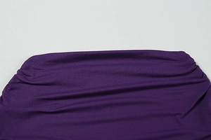 Close-up of premium purple knit fabric texture with soft drapes and fine stitching