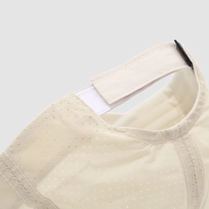 Detail of adjustable Velcro strap and breathable mesh fabric on beige kids baseball cap