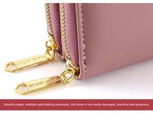 Detail of dusty pink leather wallet with dual gold-plated zippers and smooth stitching