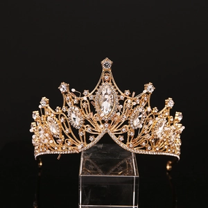 Macro shot of gold bridal tiara with intricate filigree and sparkling teardrop crystals
