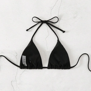Detail of black halter bikini top showing care label with 82% nylon and 18% elastane blend