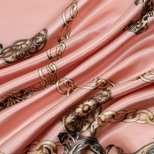 Pink leopard chain print silk satin scarf featuring elegant draped fabric texture