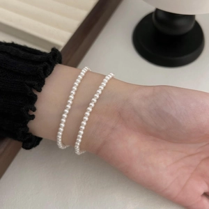 Close-up of double-layered pearl bracelet with creamy white luster on a wrist