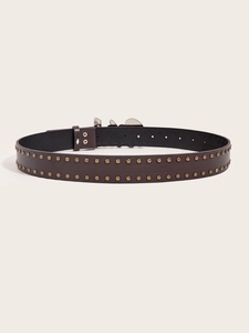 Detail of dark brown leather belt with metal studs and polished buckle for women