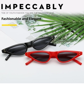 Detail shot of vintage cat-eye sunglasses with golden rivets on black and red frames