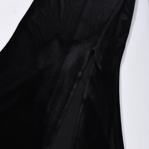 Detail of high side slit on elegant black velvet dress with soft glossy texture