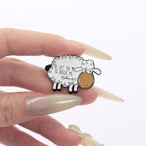 Cartoon sheep enamel pin with 'He left the 99 to rescue me' biblical quote on white background
