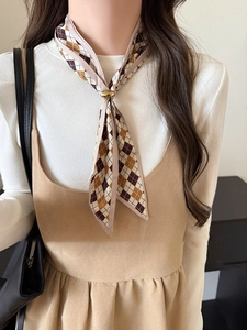 Detailed view of vintage diamond pattern silk scarf necklace with golden round ring buckle