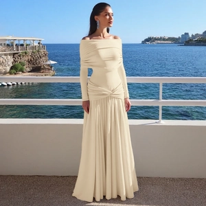 Detail of off-shoulder long-sleeve maxi dress with waist pleats and elegant draping