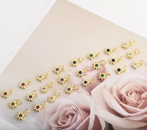 Detailed close-up of colorful zircon star charms with gold plating for jewelry making