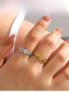 Detailed close-up of gold and silver vintage floral embossed stainless steel rings