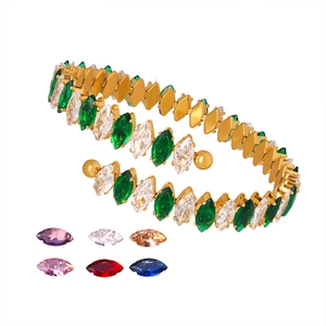 Gold open bangle featuring emerald and clear marquise zircons with colorful stone samples