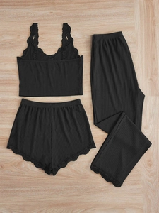 Detailed flat lay of black ribbed knit lounge set featuring delicate lace trim details