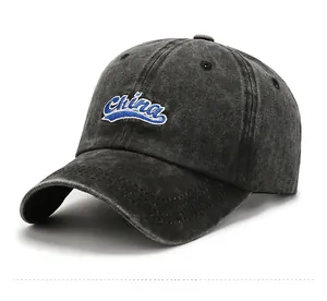 Detail of vintage washed baseball cap featuring blue China embroidery and curved brim