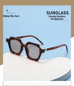 Detail of tortoise shell polygonal sunglasses with polarized grey lenses and metal accents