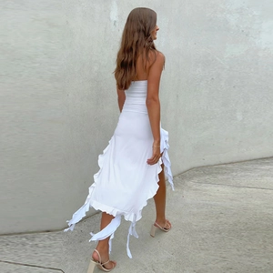 Detail view of white strapless dress with ruffled hem and slim fit silhouette