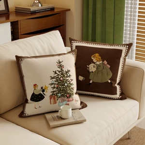 Vintage Christmas pillow cases on sofa featuring retro illustrations and holiday trees