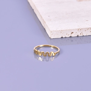 Bague ondulée minimaliste en acier titane doré posée sur une surface en marbre