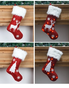 Detail of red burlap Christmas stocking with LED lights and white reindeer embroidery