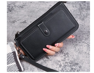 Close-up of black litchi leather long wallet with white contrast stitching and wrist strap