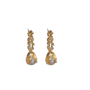 Elegant gold-tone teardrop earrings with sparkling crystal pendants and rhinestone accents