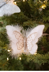 Close-up of sparkling sequin feather butterfly ornament hanging on a Christmas tree