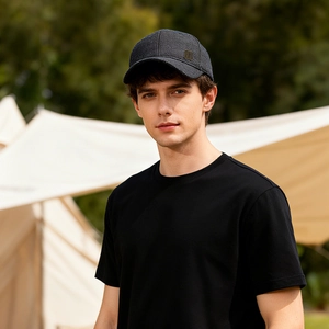 Outdoor shot of stylish men's winter baseball cap with ear protection and metal logo