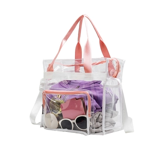 Detail of transparent PVC beach bag featuring pink handles and internal item storage