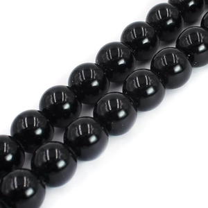 Macro shot of polished black agate round beads with smooth surface for DIY jewelry making