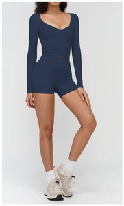 Detail view of navy blue high-stretch yoga set with deep V-neck top and high waist shorts